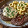 Delicious Garlic Butter Steak paired with Cheesy Alfredo Tortellini on a plate