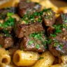 Delicious garlic herb butter steak bites pasta dish garnished with herbs