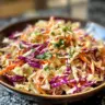 Gordon Ramsay's crunchy coleslaw served in a bowl with fresh ingredients.
