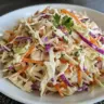 Bowl of healthy coleslaw made with fresh vegetables and a light dressing