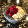 Healthy Greek yogurt chia pudding topped with fruits and seeds