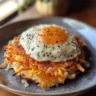 Healthy sweet potato hash browns served on a plate with a garnish