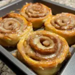 Freshly baked high-protein cinnamon rolls topped with creamy icing