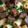 Indulgent creamy garlic parmesan steak pasta served on a plate.
