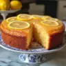 Slice of irresistible lemon cake with frosting and lemon garnish