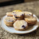 Lemon blueberry cheesecake cookies with fresh berries and creamy frosting