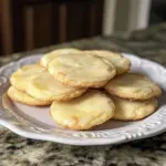 Lemon cheesecake cookies on a plate, showcasing their delicious creamy and zesty texture.
