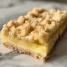 Delicious lemon crumb bars with buttery crust and tangy lemon filling.
