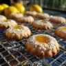 Delicious lemon curd cookies stacked on a plate with a drizzle of lemon glaze.