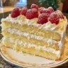 Delicious Limoncello Mascarpone Cake decorated with lemon slices and fresh cream.