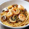 Delicious Mushroom Garlic Shrimp Pasta served with herbs and parmesan