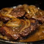 Delicious onion gravy smothered steak served with sides