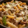 Delicious plate of Philly cheese steak pasta with beef and cheese sauce