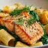 Plate of quick salmon and spinach pasta ready to eat.
