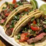 Slow cooker flank steak street tacos served with fresh toppings