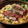 Delicious Steak Alfredo served with fettuccine pasta and creamy sauce