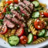 Colorful Steak Pasta Salad with fresh vegetables and grilled steak