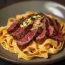 Steak Pasta dish with creamy Boursin served in a bowl