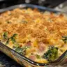 Delicious ham broccoli casserole served in a glass baking dish, garnished with cheese.