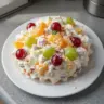 Delicious Ambrosia Salad with fruit and marshmallows served in a bowl
