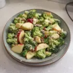 Fresh Apple Broccoli Salad with nuts and dressing served in a bowl