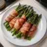 Bacon wrapped asparagus bundles on a serving platter