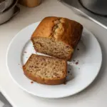 Loaf of freshly baked banana bread with slices cut