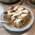 Delicious homemade bread pudding with caramel sauce and raisins.