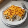 Delicious Chicken Bacon Ranch Casserole topped with crispy bacon and melted cheese.