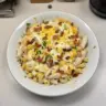 Creamy Chicken Bacon Ranch Pasta Casserole dish with toppings