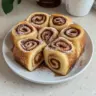 Delicious cinnamon roll French toast roll-ups garnished with icing and cinnamon.
