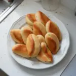 Freshly baked Coco Bread, a soft and sweet Caribbean treat, ready to be enjoyed.
