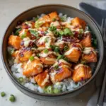 Crispy Salmon served on a bed of rice with vegetables in a bowl