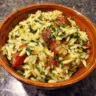 A vibrant bowl of delicious orzo salad with fresh vegetables