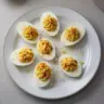 Delicious deviled eggs on a platter, garnished and ready to serve.