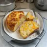 Freshly baked Dutch Oven Cheddar Bread with a golden crust and melted cheese