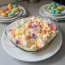 Colorful Easter Fluff Salad with marshmallows, fruits, and creamy topping.