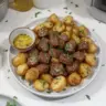 Garlic Butter Beef Bites with Potatoes on a plate, garnished and ready to serve