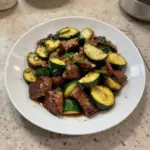 Garlic butter steak bites served on a rustic plate with herbs