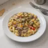 High-protein creamy Philly cheesesteak mac and cheese served in a bowl