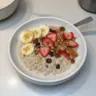 Bowl of high-protein overnight oats topped with fruits and nuts