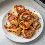 High protein pepperoni pizza rolls served on a plate