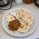 Freshly baked homemade pita bread rising in the oven.