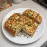 Freshly baked Italian Herbs and Cheese Bread with herbs and cheese on top