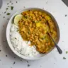 Bowl of Jamaican Black-eyed Pea Curry garnished with fresh herbs