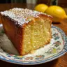 Delicious Limoncello Cake with lemon glaze and zest on a white plate
