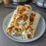 Low carb cheesy garlic chicken wraps with fresh vegetables and melted cheese