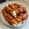 Nashville hot bacon wrapped mozzarella sticks served with dipping sauce