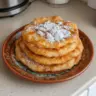 A plate of golden brown Navajo Fry Bread served with toppings.