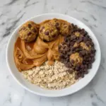 No-bake peanut butter energy bites on a plate, ready to eat.